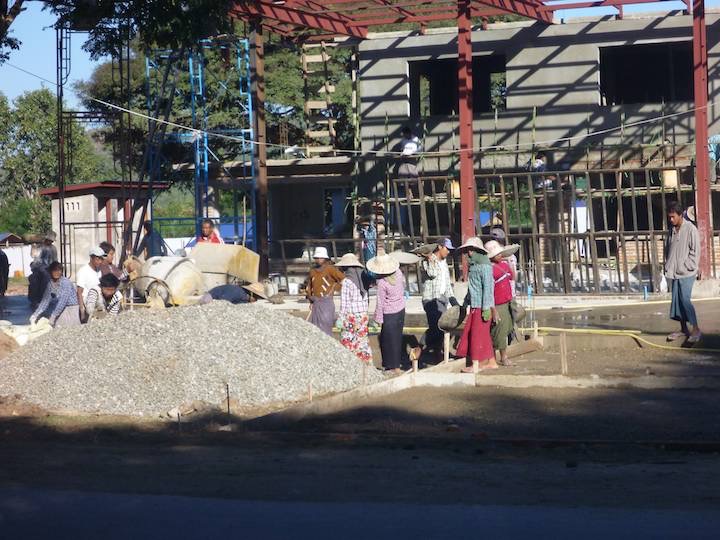 Men and women work on a construction site