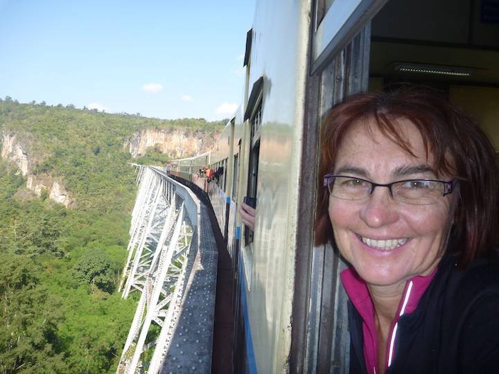 The train goes very slowly across the viaduct.