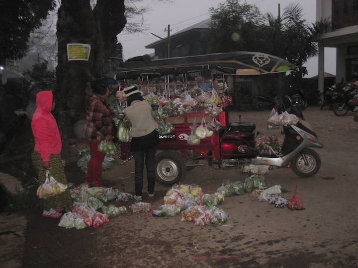 A 3 wheeler getting ready to do his rounds after buying at the morning market.